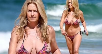 Penny Lancaster, 52, Flaunts Her Incredible Figure In Red Bikini As She Frolics On The Beach In Sydney